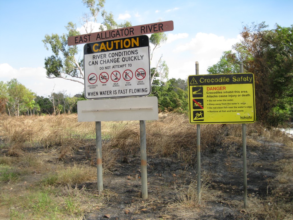 Road signs at East Alligator River right at the border to Kakadu National Park on the Arnhem Land side