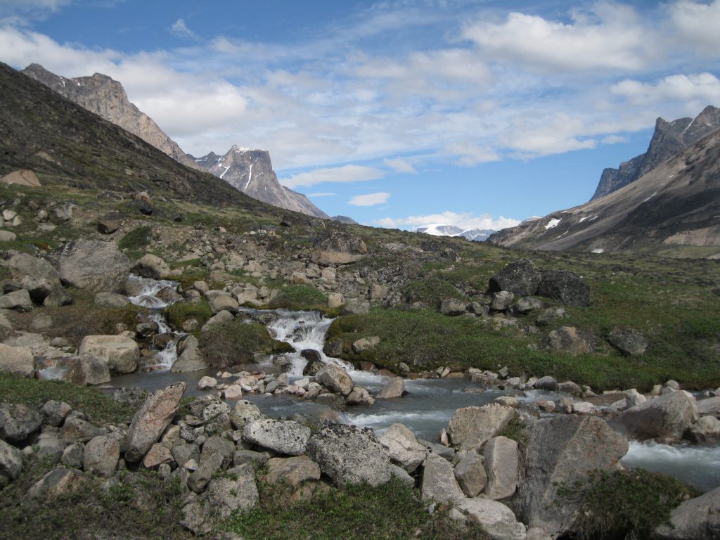 The valley, a stream and cascades with the Highway Glacier in the distance