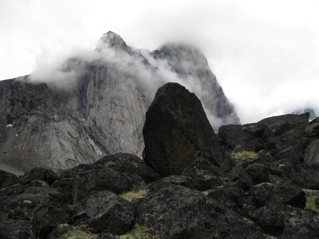 Mount Thor in the mist fronted by boulders