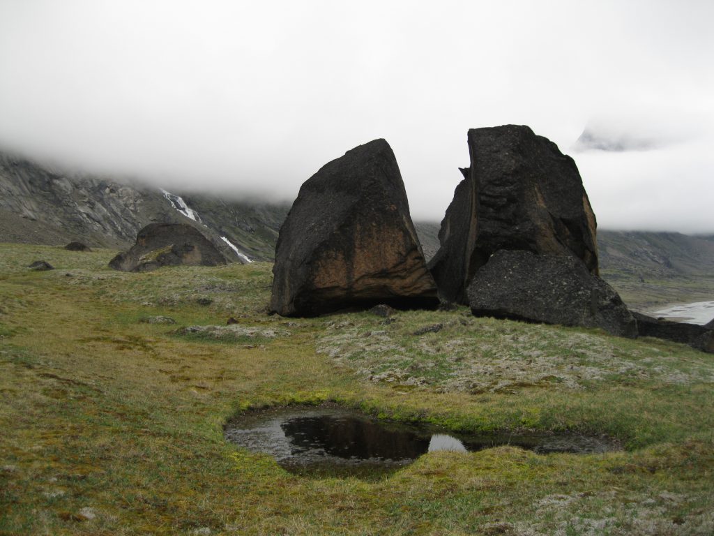 Boulders at "The Crib" fronted by a Pond and Schwarzenbach Falls in the mist in the background